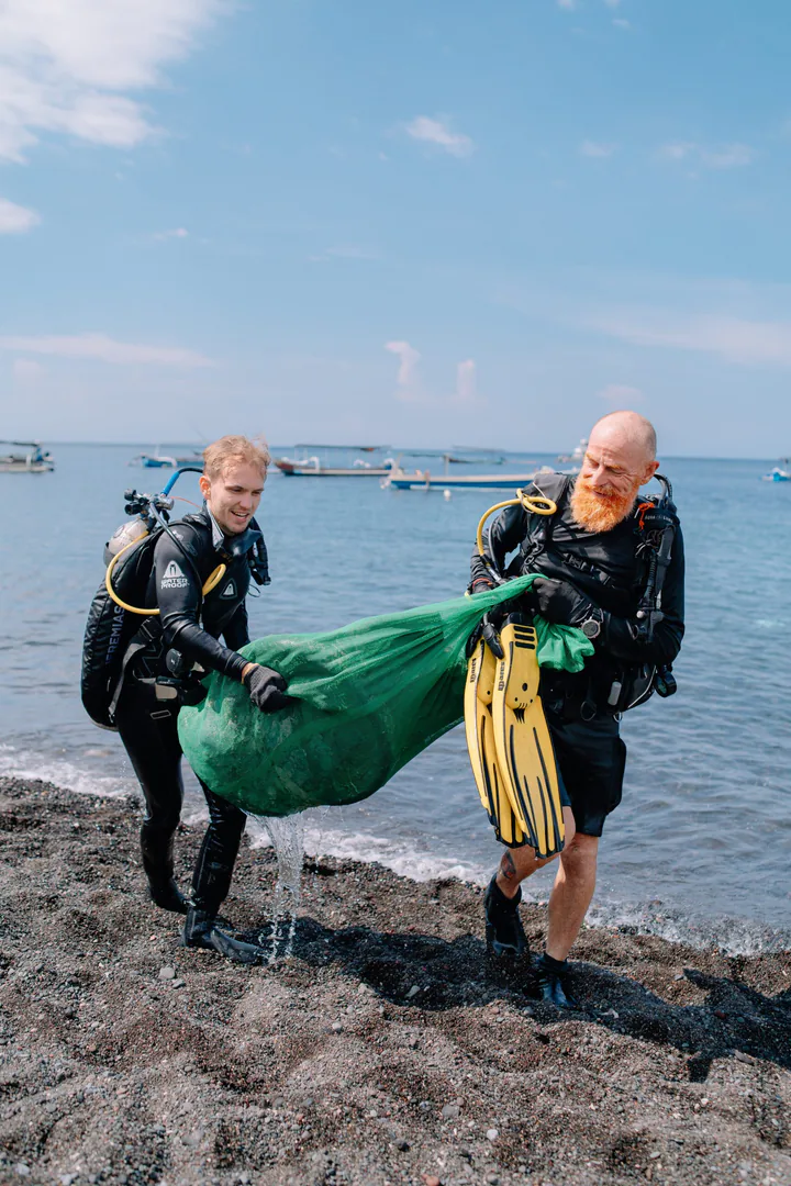 Volunteers sorting collected waste on the beach after a cleanup dive in Bali