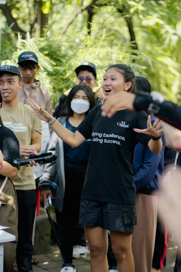 An MS Capital team member briefing volunteers before a cleanup event in Bali